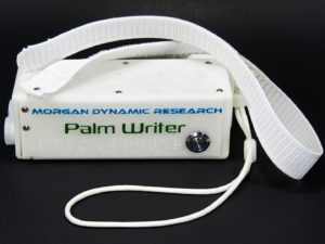 Palm Writer Top View Showing Top and Right Plates, Power Button, Wrist Strap, and Ergonomic Suspension Kit