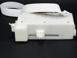 A Palm Writer bottom view showing the tactile feedback unit, or writer, Wrist Rest, Suspension Strap and bottom plate